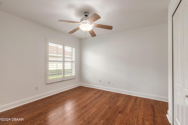 spare room featuring ceiling fan and dark hardwood / wood-style flooring