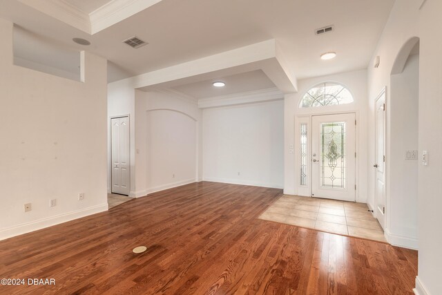 entrance foyer with light wood-type flooring and ornamental molding