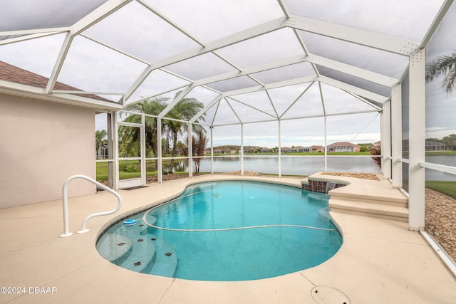 view of swimming pool with glass enclosure, a patio area, and a water view