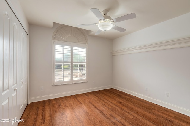 empty room with hardwood / wood-style floors and ceiling fan