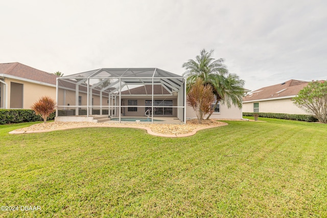 rear view of property with a lawn and glass enclosure