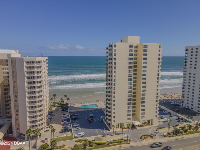 exterior space with a water view and a beach view