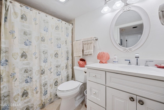 bathroom with tile patterned floors, a shower with curtain, vanity, and toilet