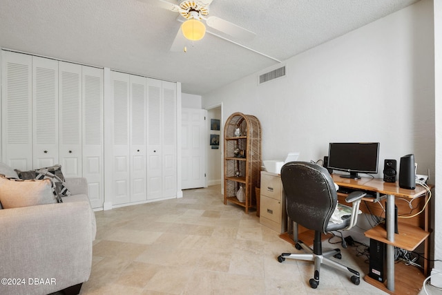 office featuring a textured ceiling and ceiling fan