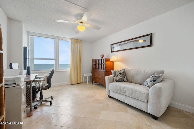 home office with ceiling fan and a textured ceiling