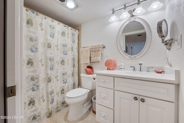 bathroom with tile patterned floors, curtained shower, vanity, and toilet