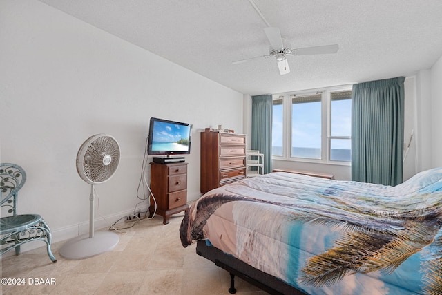 bedroom featuring a textured ceiling and ceiling fan