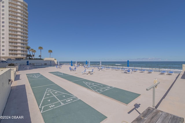 view of home's community featuring a water view and a view of the beach