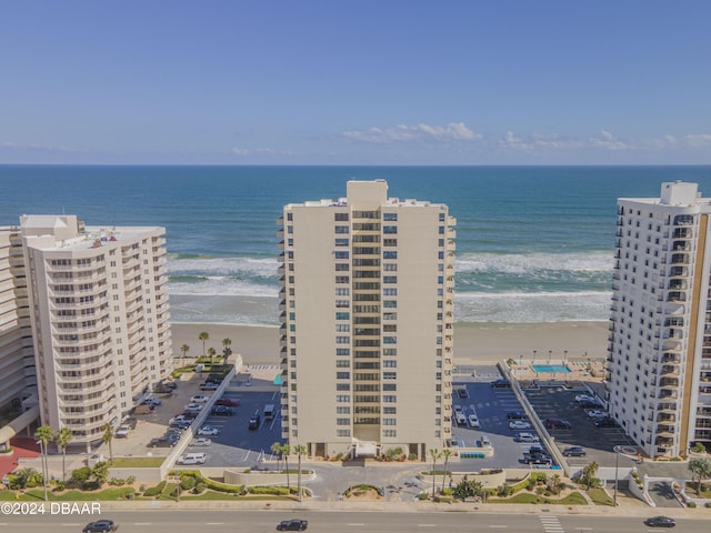 drone / aerial view with a water view and a view of the beach