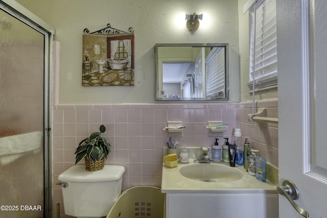 bathroom featuring vanity, toilet, and a shower with shower door