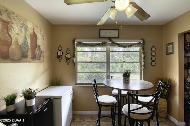 dining area featuring light tile patterned flooring