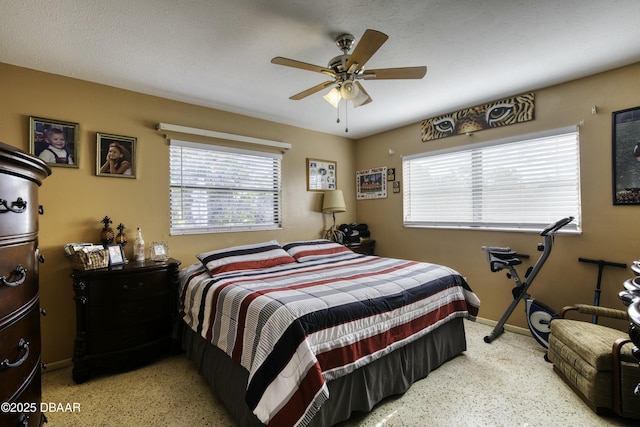 bedroom featuring ceiling fan and multiple windows