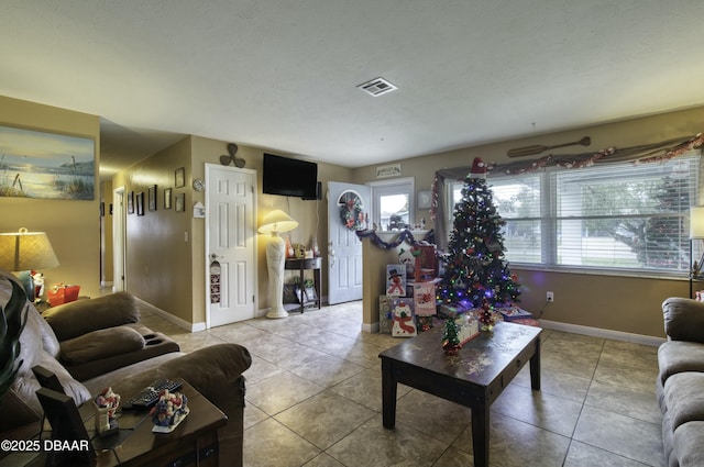 tiled living room with a textured ceiling