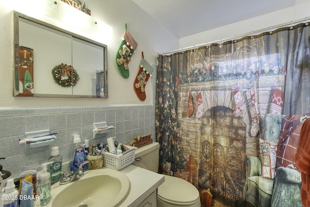 bathroom with a shower with curtain, vanity, toilet, and tile walls