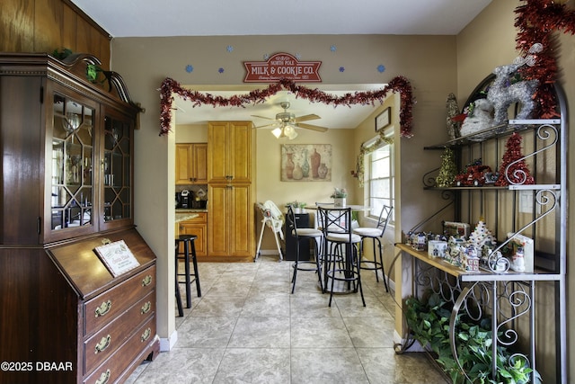 dining room with ceiling fan and light tile patterned floors