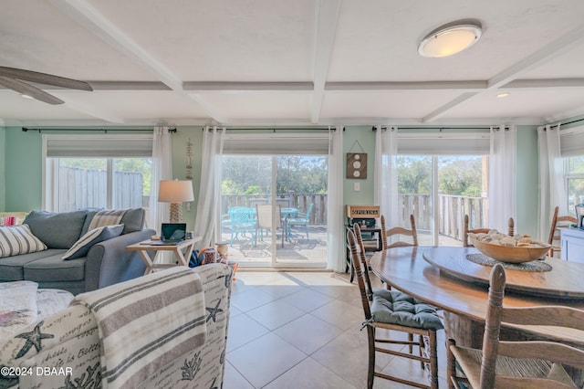 dining area featuring beamed ceiling, ceiling fan, and light tile patterned flooring