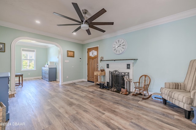 sitting room featuring ornamental molding, light hardwood / wood-style floors, and ceiling fan