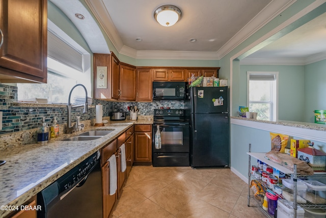 kitchen with black appliances, crown molding, light stone countertops, decorative backsplash, and sink