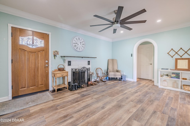 entryway featuring ceiling fan, light hardwood / wood-style flooring, and ornamental molding