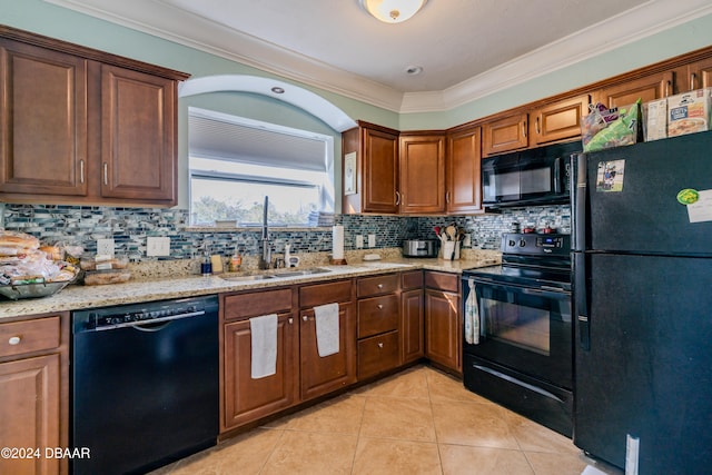 kitchen with black appliances, decorative backsplash, sink, and ornamental molding