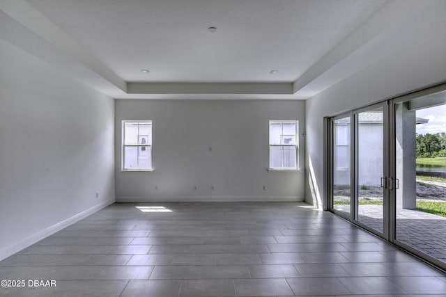1316 Loftwedge Cir, Daytona Beach, FL 32124 - spare room featuring healthy amount of natural light and a tray ceiling