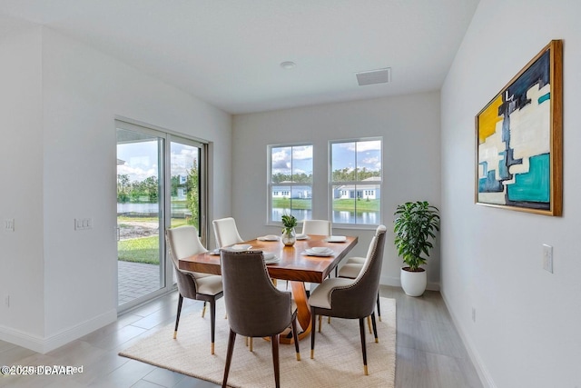1316 Loftwedge Cir, Daytona Beach, FL 32124 - dining room featuring baseboards and a water view