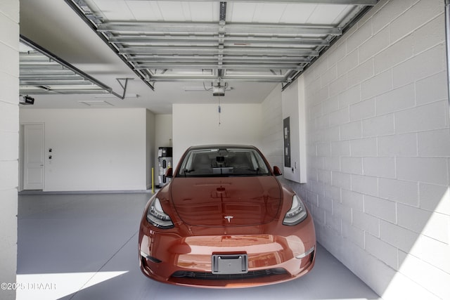 1316 Loftwedge Cir, Daytona Beach, FL 32124 - garage featuring a garage door opener, concrete block wall, and electric panel