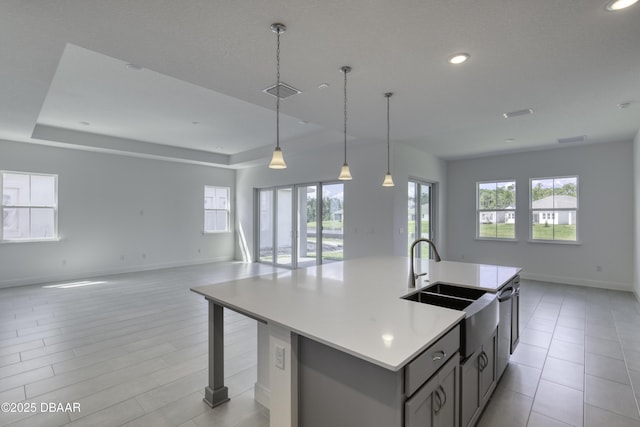1316 Loftwedge Cir, Daytona Beach, FL 32124 - kitchen featuring open floor plan, gray cabinetry, recessed lighting, a kitchen island with sink, and light countertops