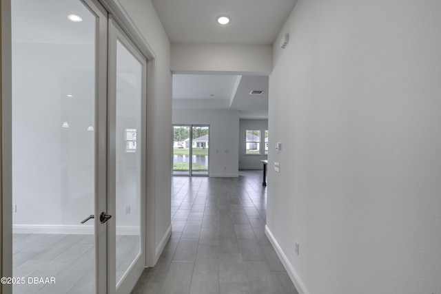 1316 Loftwedge Cir, Daytona Beach, FL 32124 - hallway featuring recessed lighting, light tile patterned floors, and a tray ceiling