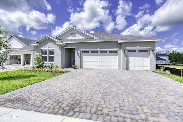 1316 Loftwedge Cir, Daytona Beach, FL 32124 - view of front of property with decorative driveway, a garage, stucco siding, and a front lawn