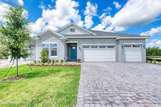1316 Loftwedge Cir, Daytona Beach, FL 32124 - single story home featuring decorative driveway, a garage, a front yard, and stucco siding