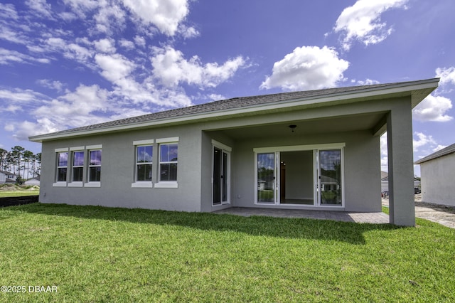 1316 Loftwedge Cir, Daytona Beach, FL 32124 - back of house with stucco siding and a yard