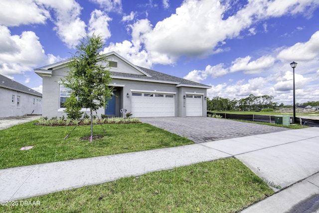 1316 Loftwedge Cir, Daytona Beach, FL 32124 - view of front facade featuring stucco siding, decorative driveway, an attached garage, and a front lawn