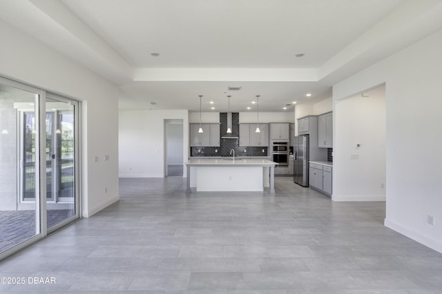 1316 Loftwedge Cir, Daytona Beach, FL 32124 - kitchen featuring gray cabinets, wall chimney range hood, stainless steel appliances, light countertops, and tasteful backsplash