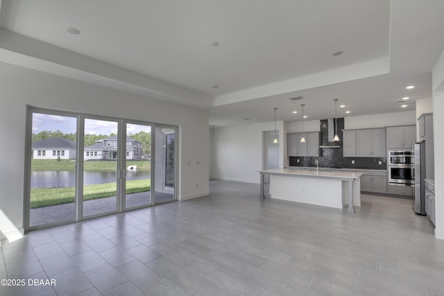 1316 Loftwedge Cir, Daytona Beach, FL 32124 - unfurnished living room with a tray ceiling, recessed lighting, and a water view