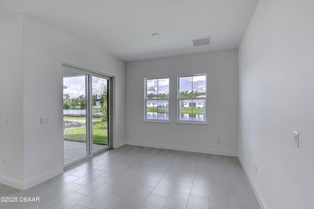 1316 Loftwedge Cir, Daytona Beach, FL 32124 - empty room with a water view and light tile patterned flooring