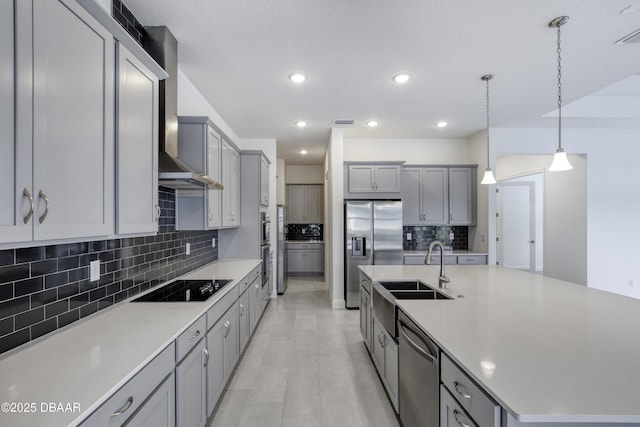 1316 Loftwedge Cir, Daytona Beach, FL 32124 - kitchen with appliances with stainless steel finishes, wall chimney range hood, gray cabinets, a large island with sink, and backsplash