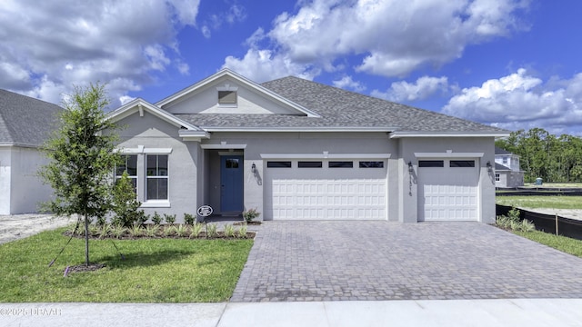 1316 Loftwedge Cir, Daytona Beach, FL 32124 - ranch-style house with a garage, decorative driveway, stucco siding, a front lawn, and a shingled roof