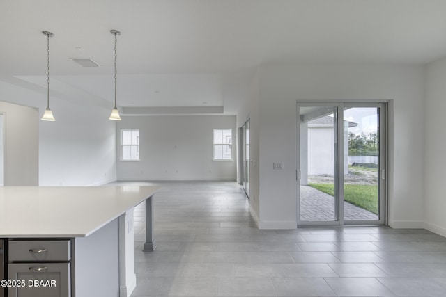 1316 Loftwedge Cir, Daytona Beach, FL 32124 - kitchen with light countertops, decorative light fixtures, open floor plan, and light tile patterned flooring