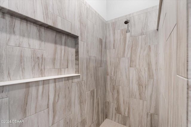 bathroom with a tile shower