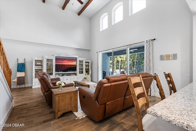 living room with high vaulted ceiling, beamed ceiling, dark hardwood / wood-style floors, and ceiling fan