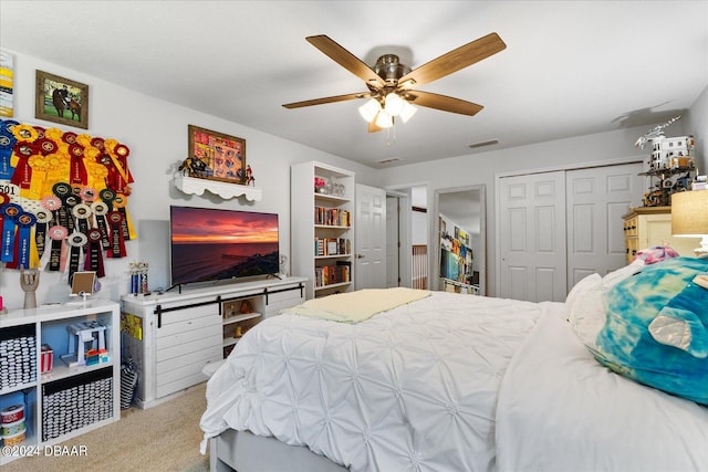 bedroom with ceiling fan, a closet, and light colored carpet