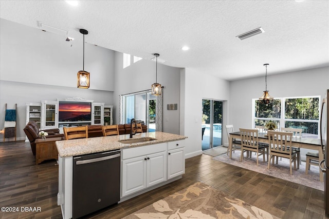 kitchen featuring dark hardwood / wood-style flooring, white cabinetry, stainless steel dishwasher, and sink