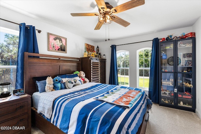 bedroom with light carpet and ceiling fan