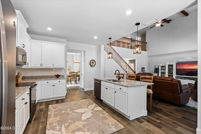 kitchen featuring a kitchen island with sink, white cabinets, sink, and stainless steel appliances