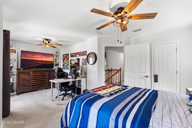 bedroom with a textured ceiling, light colored carpet, and ceiling fan