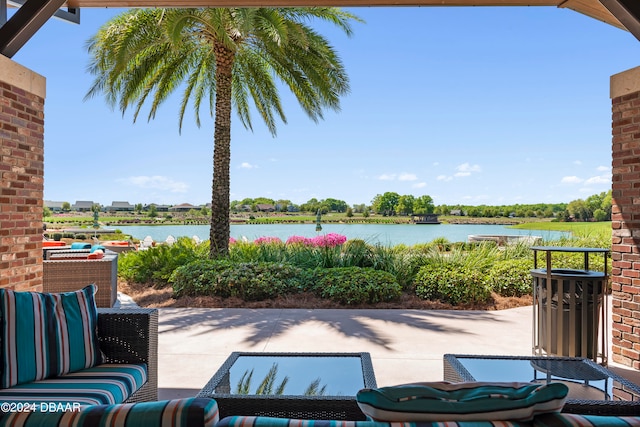 view of patio with an outdoor living space and a water view