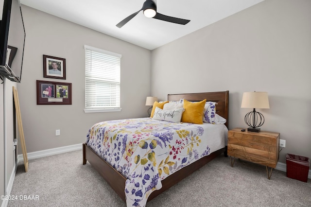 bedroom with ceiling fan and light colored carpet