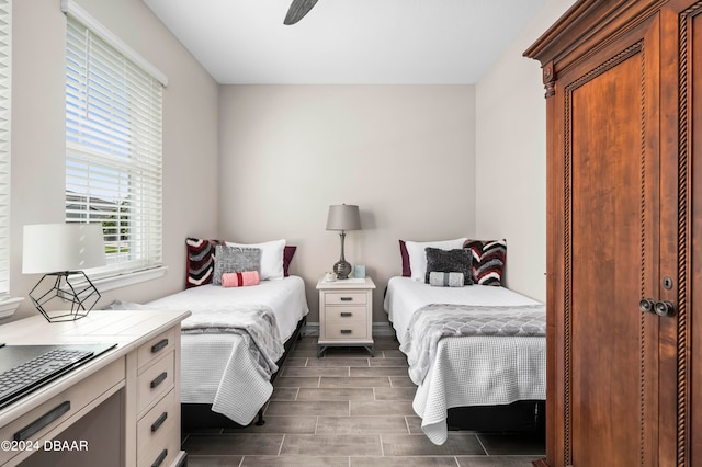 bedroom with ceiling fan and dark wood-type flooring