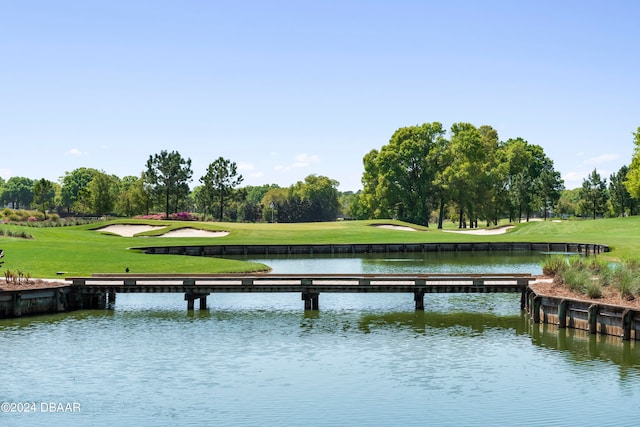 exterior space featuring a water view and a lawn